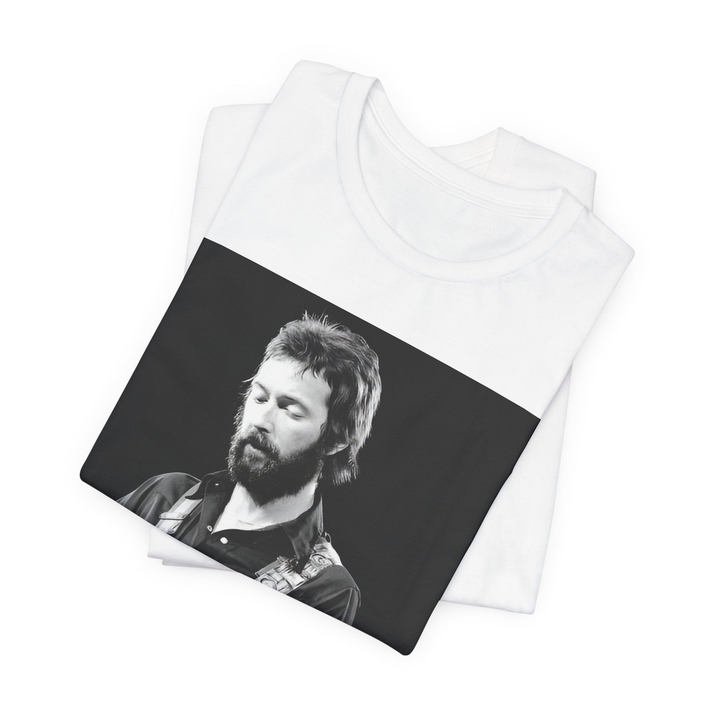 A black graphic t-shirt featuring a graphic or photo of Eric Clapton performing live on stage with his guitar.