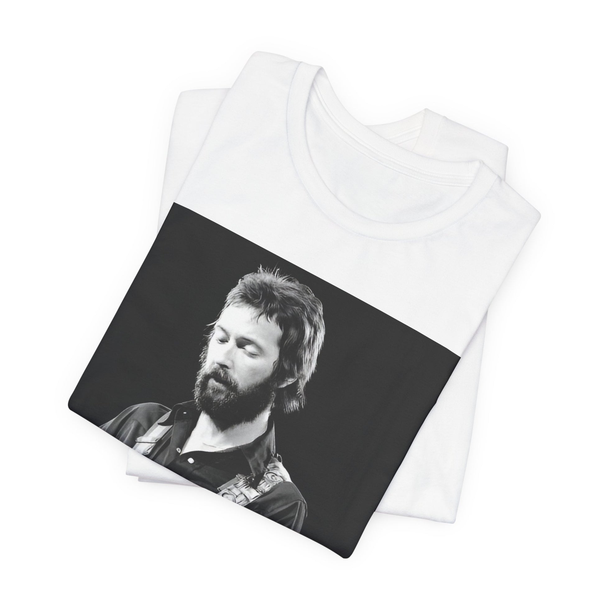 A black graphic t-shirt featuring a graphic or photo of Eric Clapton performing live on stage with his guitar.