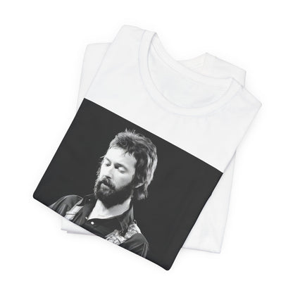 A black graphic t-shirt featuring a graphic or photo of Eric Clapton performing live on stage with his guitar.