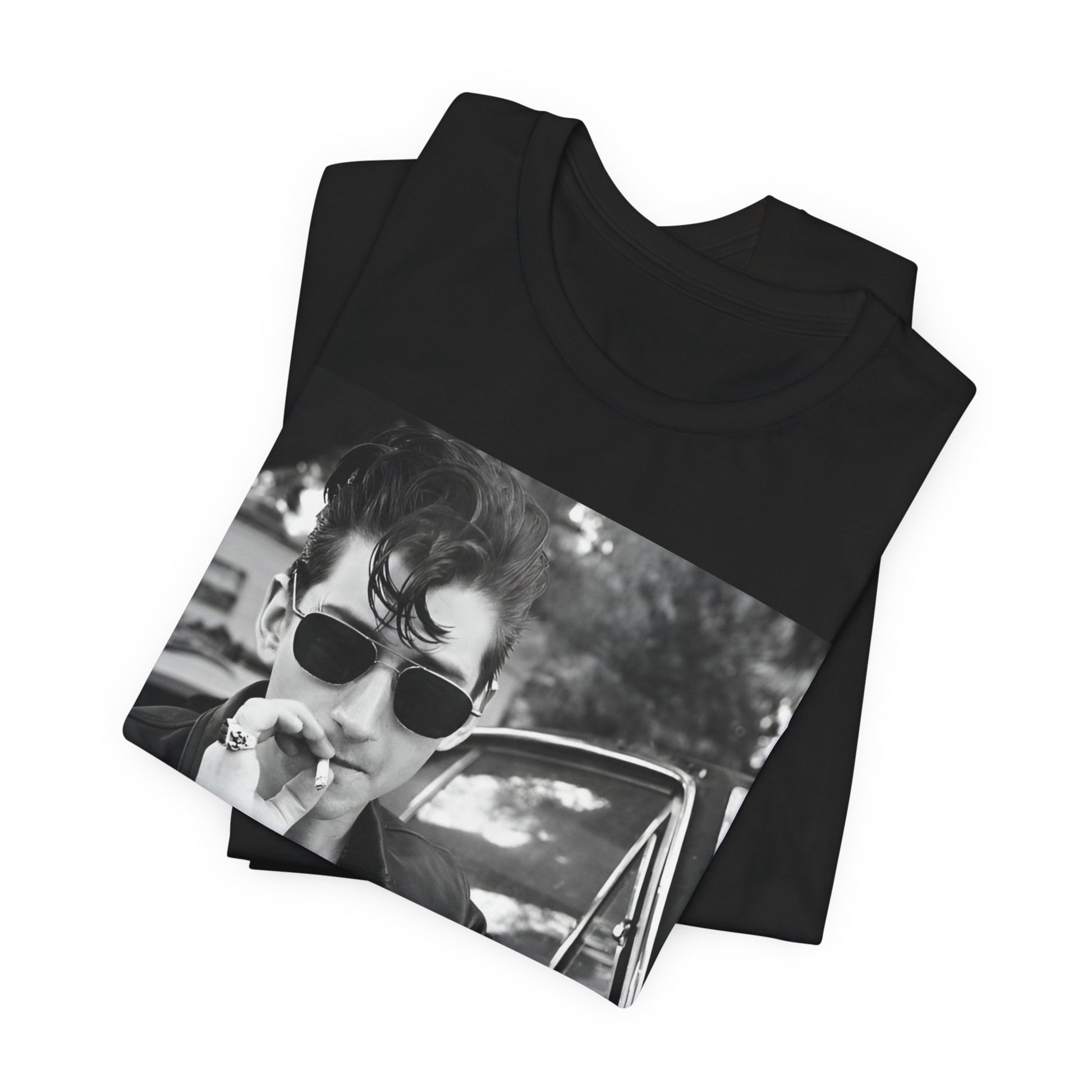 A black graphic t-shirt featuring a classic rock-style graphic of the Arctic Monkeys, possibly with band members in a stylized design.