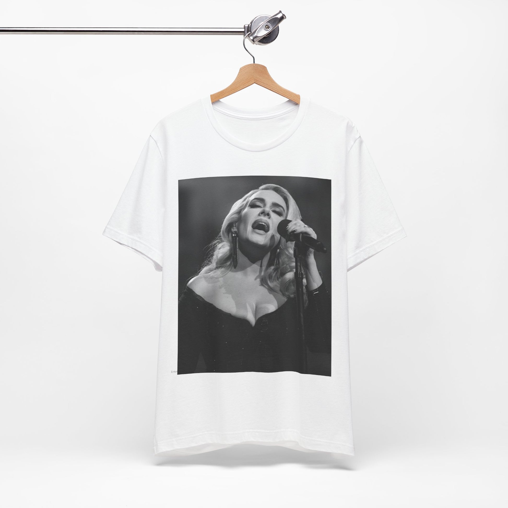 A black graphic t-shirt featuring a dynamic image of Adele performing on stage, with lighting effects, likely from her 'One Night Only' concert special.