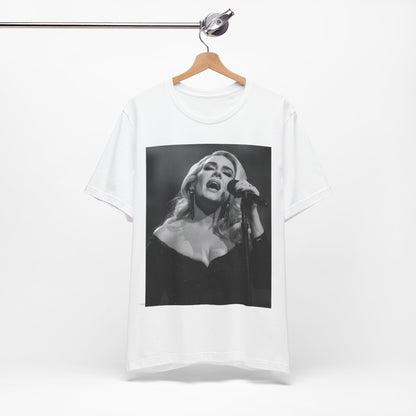 A black graphic t-shirt featuring a dynamic image of Adele performing on stage, with lighting effects, likely from her 'One Night Only' concert special.