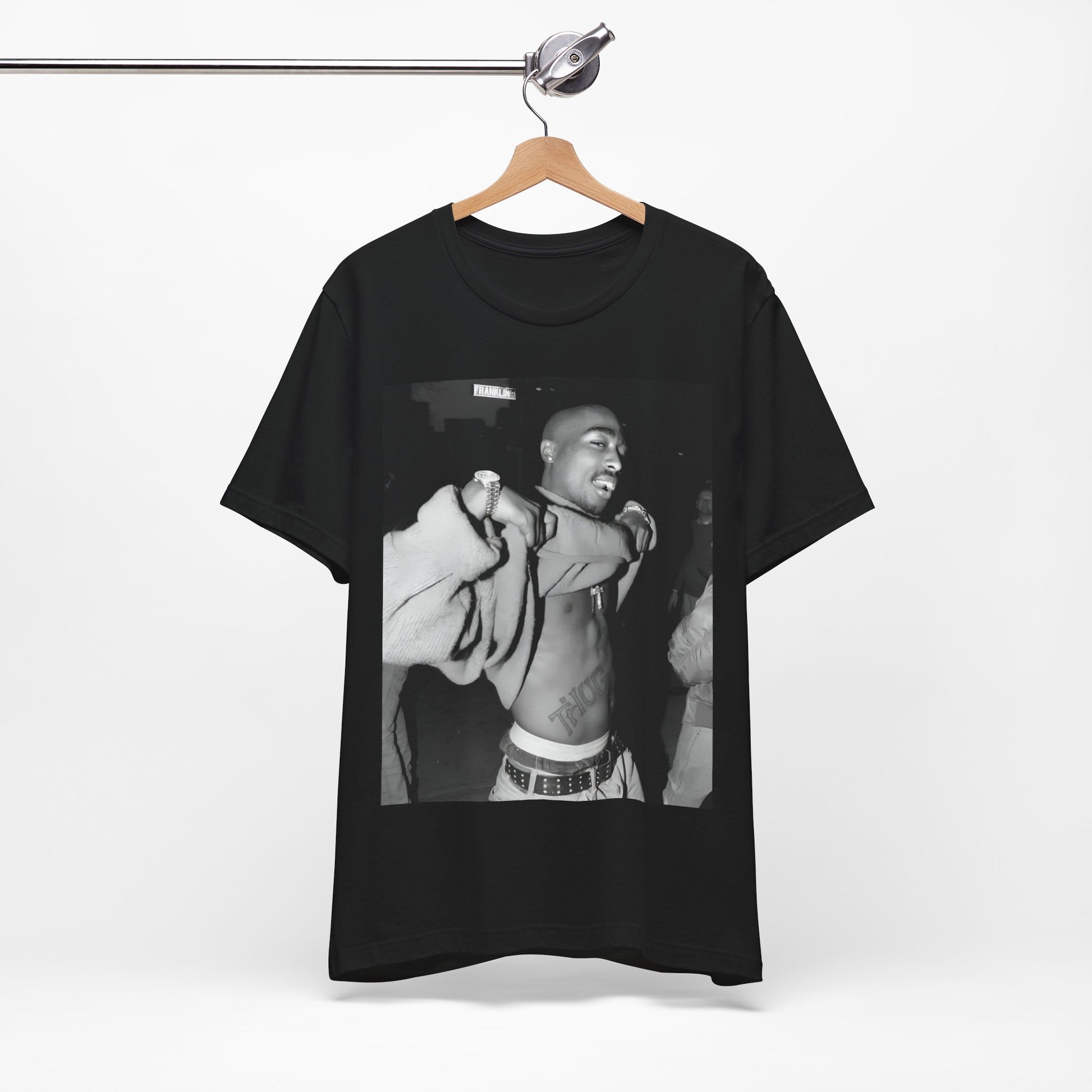 A black graphic t-shirt featuring a vintage hip hop icon graphic of Tupac.