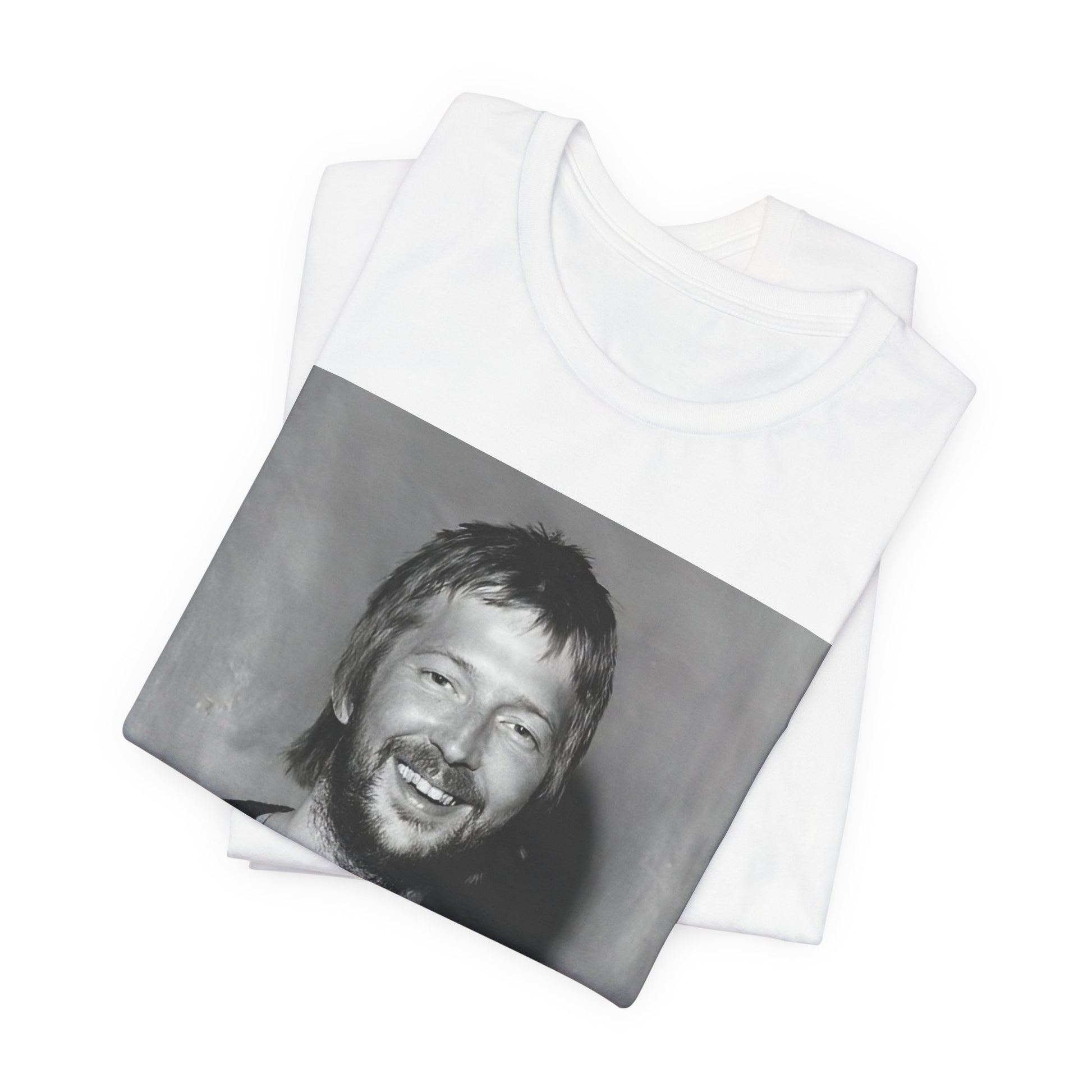 A black graphic t-shirt featuring a 70s photo portrait of Eric Clapton.