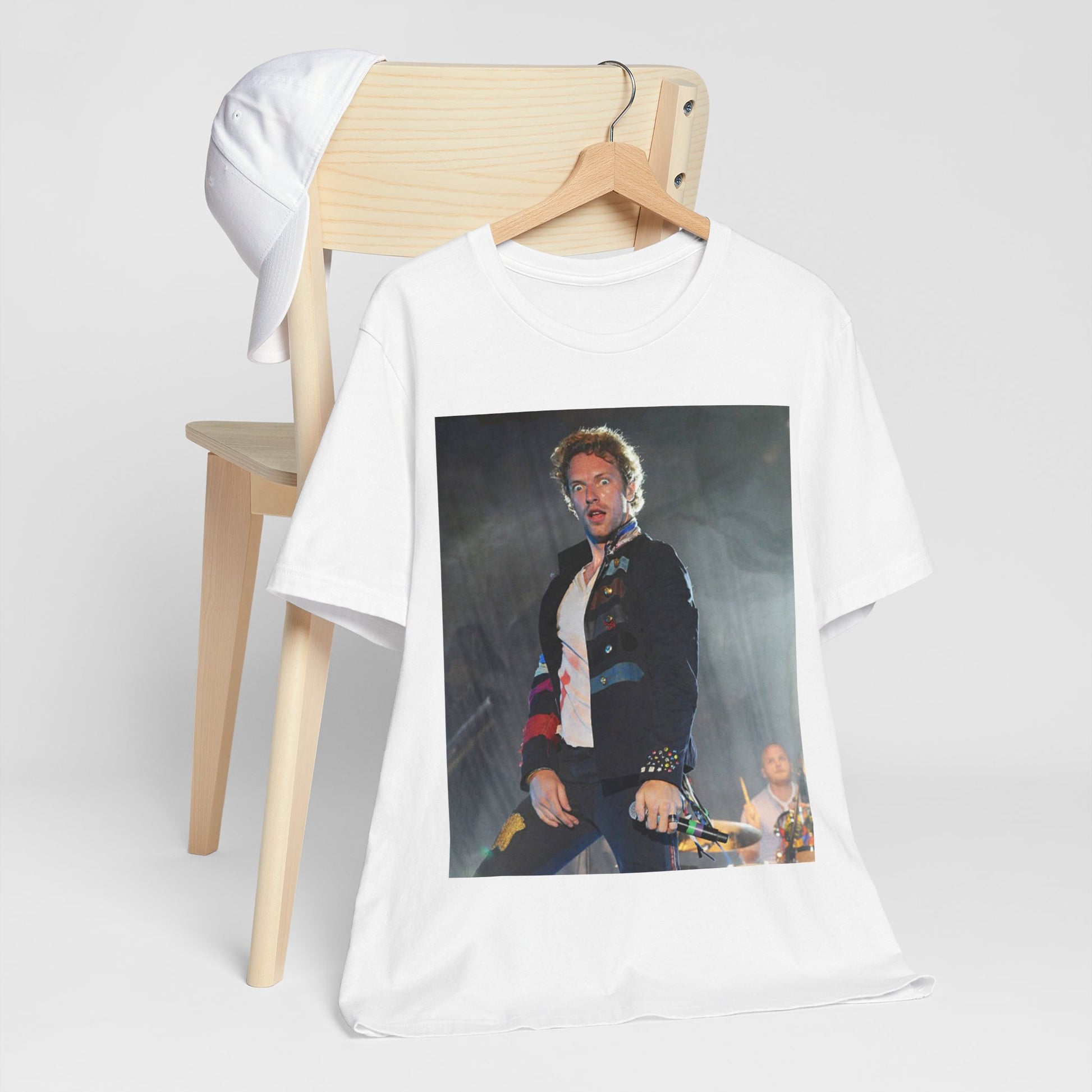 A black graphic t-shirt featuring a vintage graphic of Coldplay performing live acoustically.
