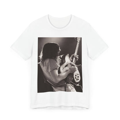 A black graphic t-shirt featuring a black and white graphic or photo of Tame Impala performing live on stage.