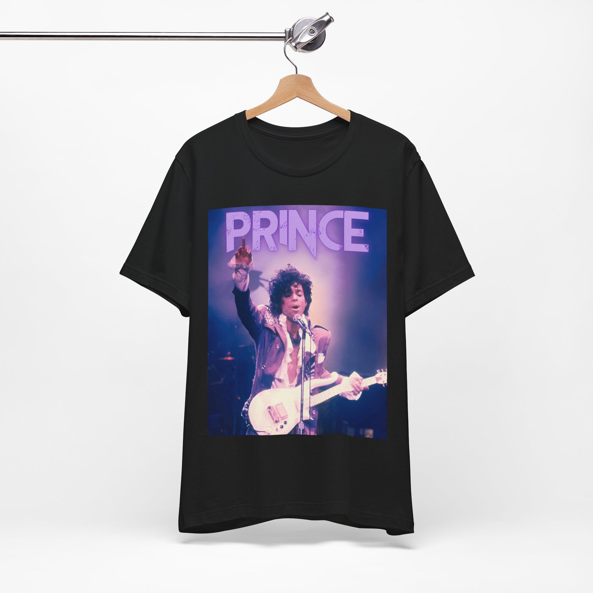 A black graphic t-shirt featuring a retro graphic related to Prince's 'Purple Rain' album era.