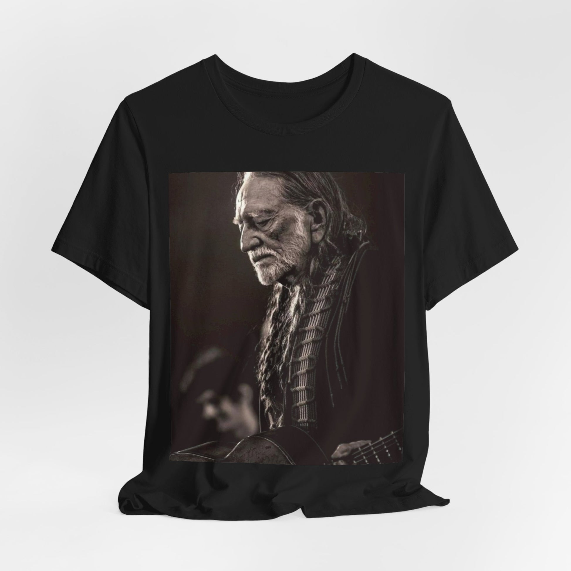 A black graphic t-shirt featuring a vintage country legend graphic of Willie Nelson.