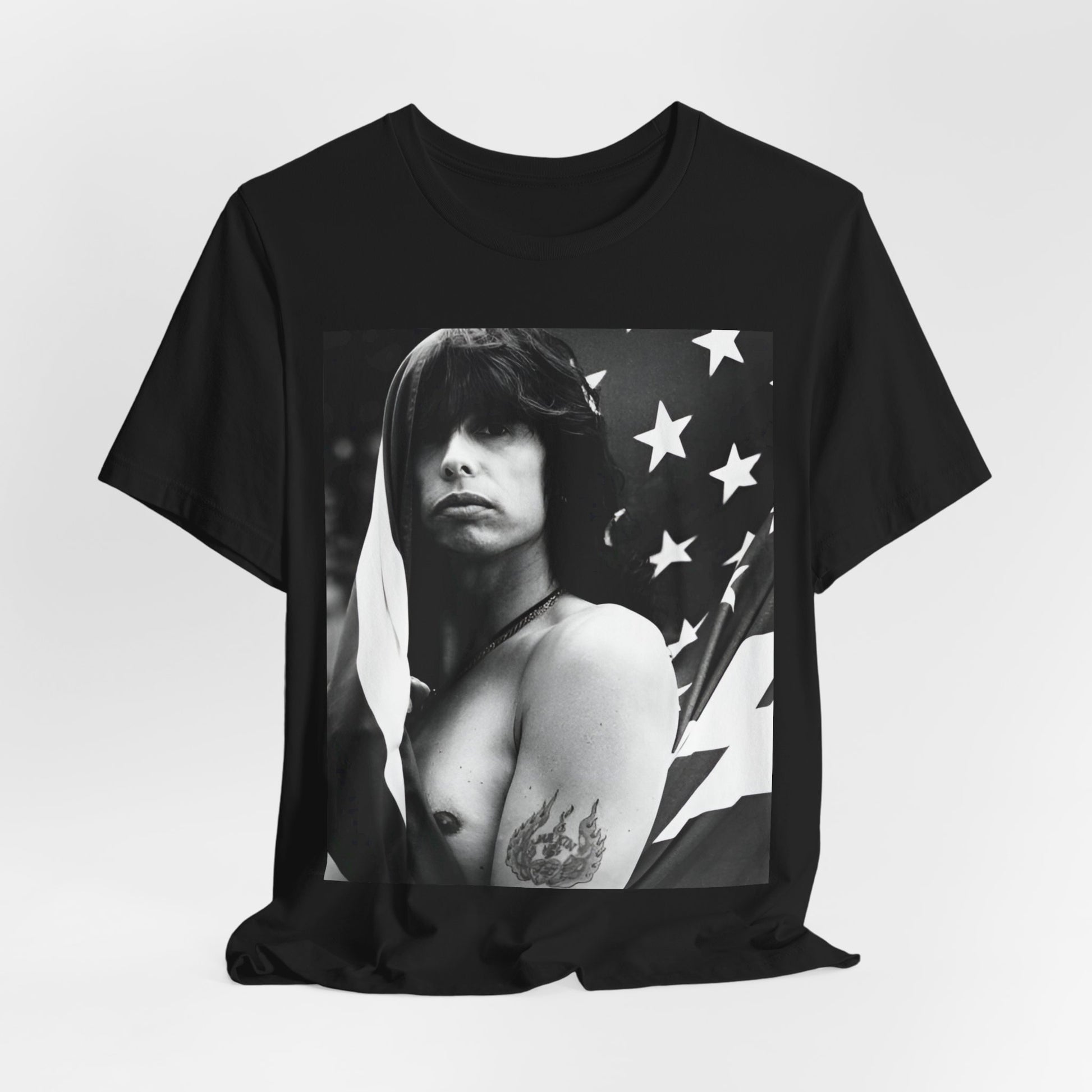 A black graphic t-shirt featuring a retro 70s-style illustration or photo of Aerosmith, integrated with elements of the American flag.