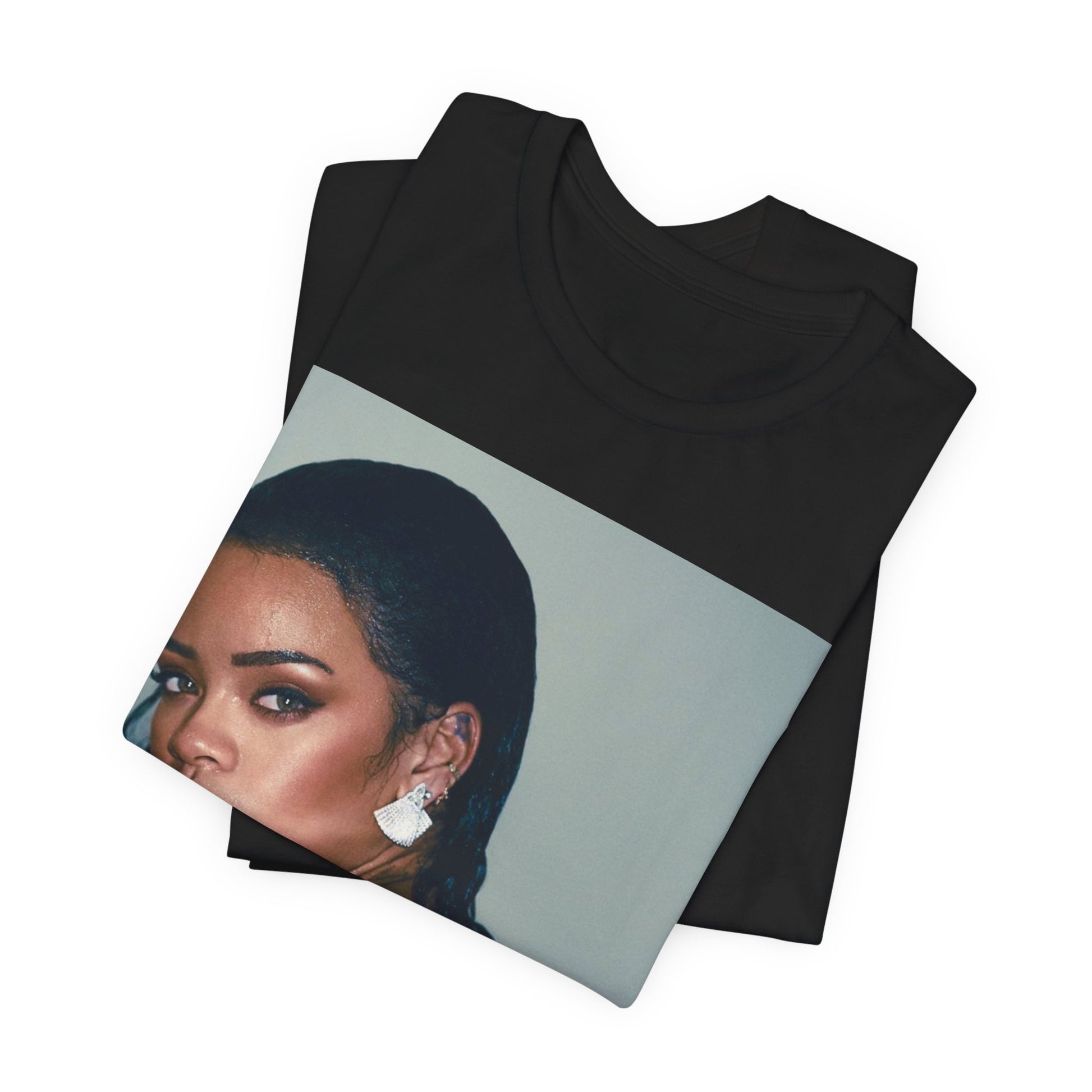 A black graphic t-shirt featuring a vintage pop icon graphic of Rihanna.