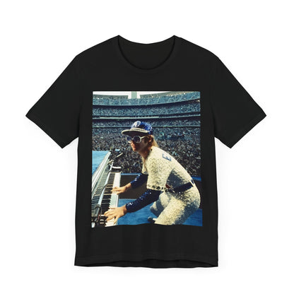 A black graphic t-shirt featuring a photo of Elton John from his 1975 Dodgers Stadium concert.