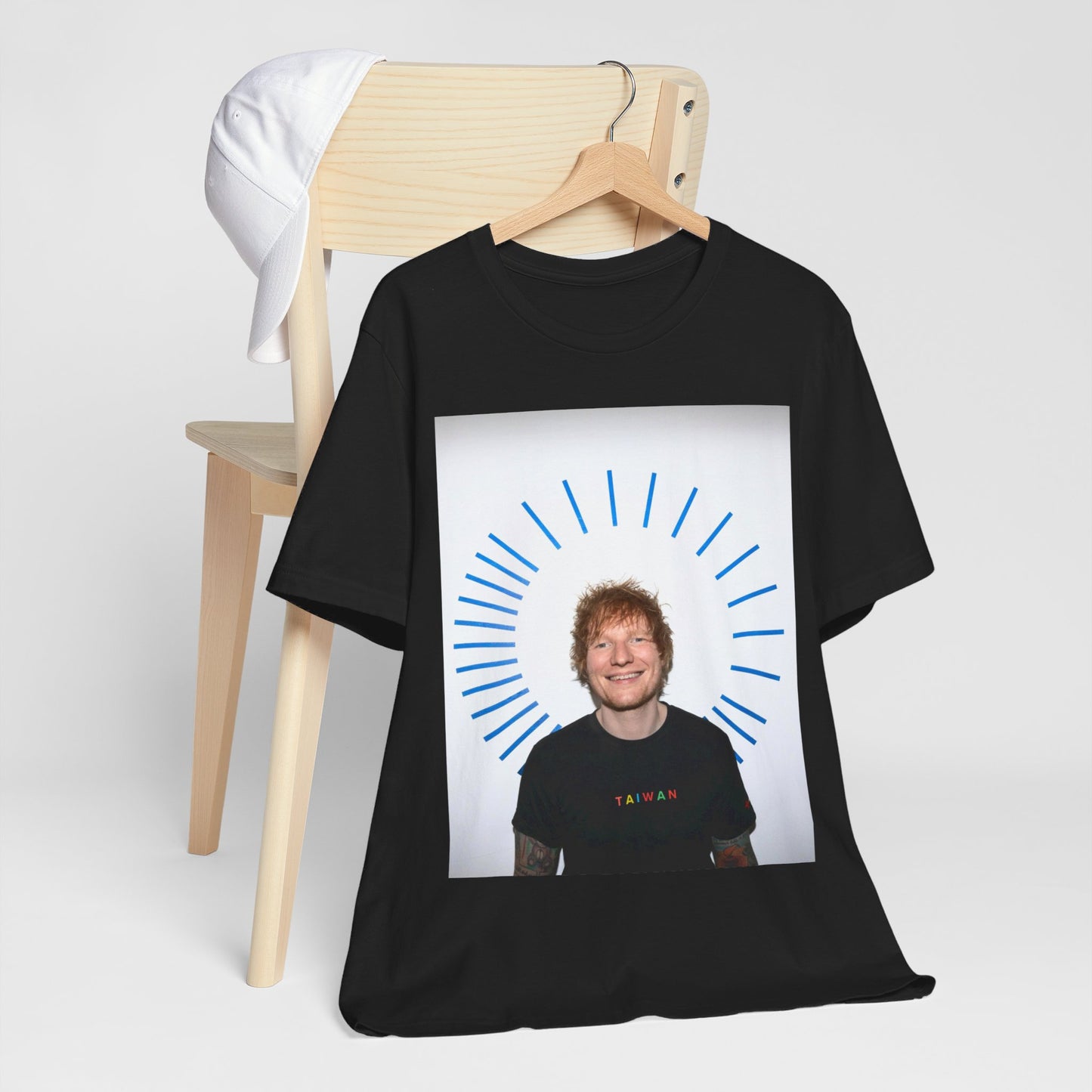 A black graphic t-shirt featuring a classic photo portrait of Ed Sheeran in a folk-pop style.