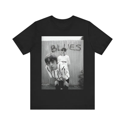 A black graphic t-shirt featuring a graphic of Liam and Noel Gallagher from Oasis, showing their support for Manchester City.