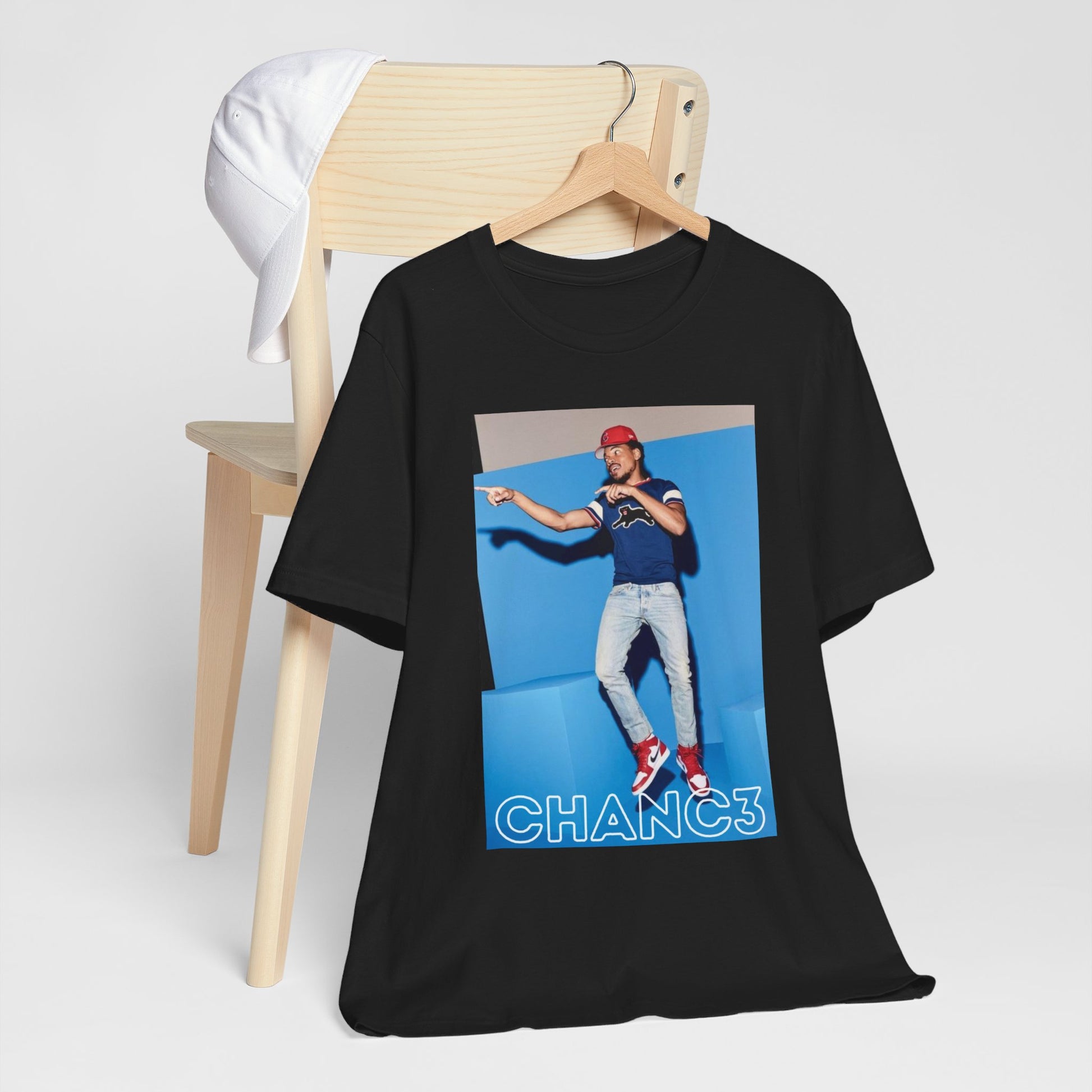 A black graphic t-shirt featuring a graphic of Chance the Rapper emphasizing his gospel rap style.