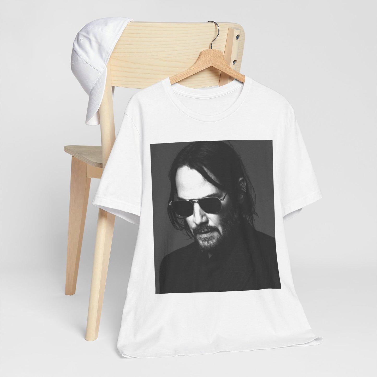 A black graphic t-shirt featuring a graphic of Keanu Reeves with a rebel spirit aesthetic.