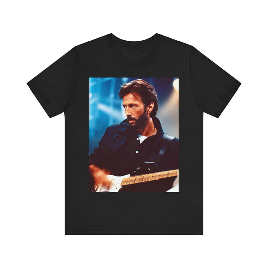 A black graphic t-shirt featuring a retro graphic or photo of Eric Clapton performing live on stage.
