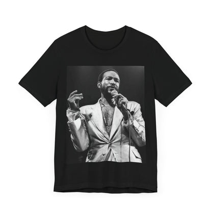 A black graphic t-shirt featuring a retro black and white photo or graphic of Marvin Gaye performing live on stage.