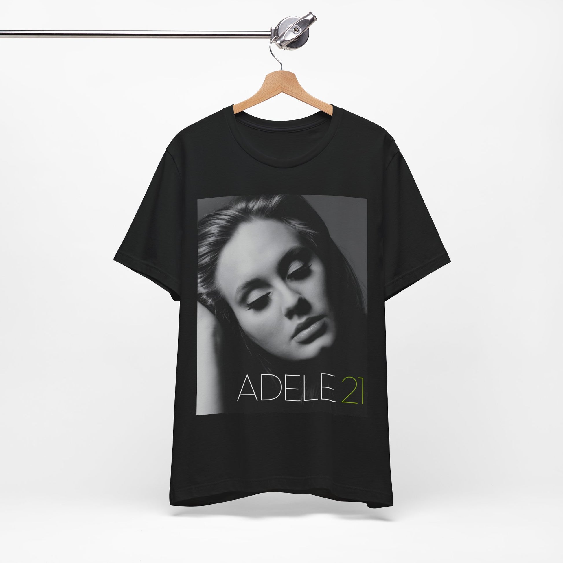 A black graphic t-shirt featuring the album cover art for Adele's '21' album, showing a close-up portrait of her with a contemplative expression.