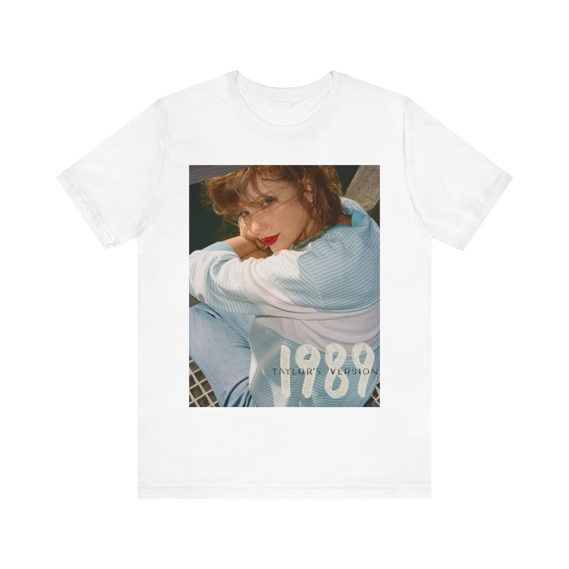 A black graphic t-shirt featuring a 1989 aesthetic graphic of Taylor Swift.