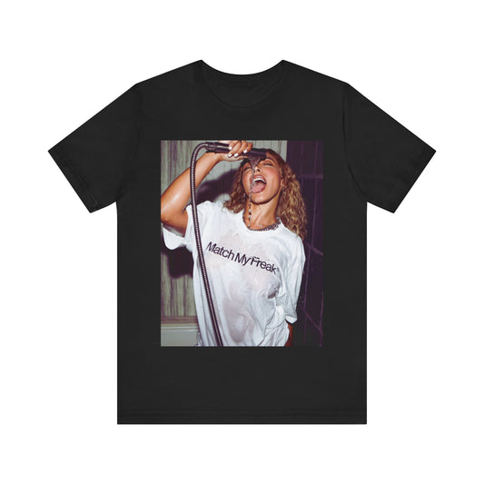A black graphic t-shirt featuring an aesthetic graphic of Tinashe with a 'Nasty' vibe.