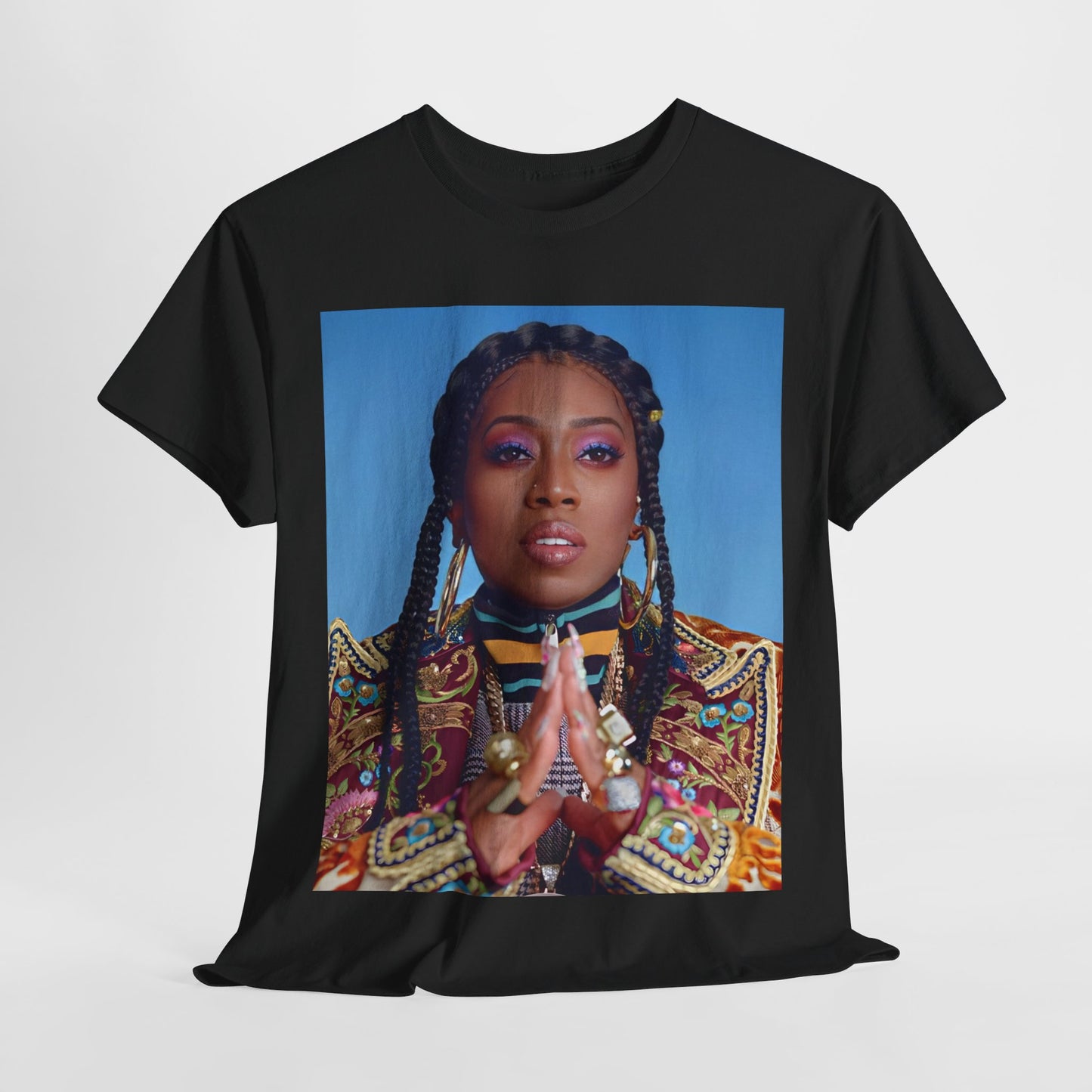 A black graphic t-shirt featuring a graphic of Missy Elliott with a cool, futuristic rap fashion aesthetic.