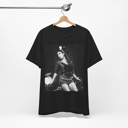 A black graphic t-shirt featuring a graphic related to Amy Winehouse's 'Frank' album era from 2003, possibly with early portrait imagery.