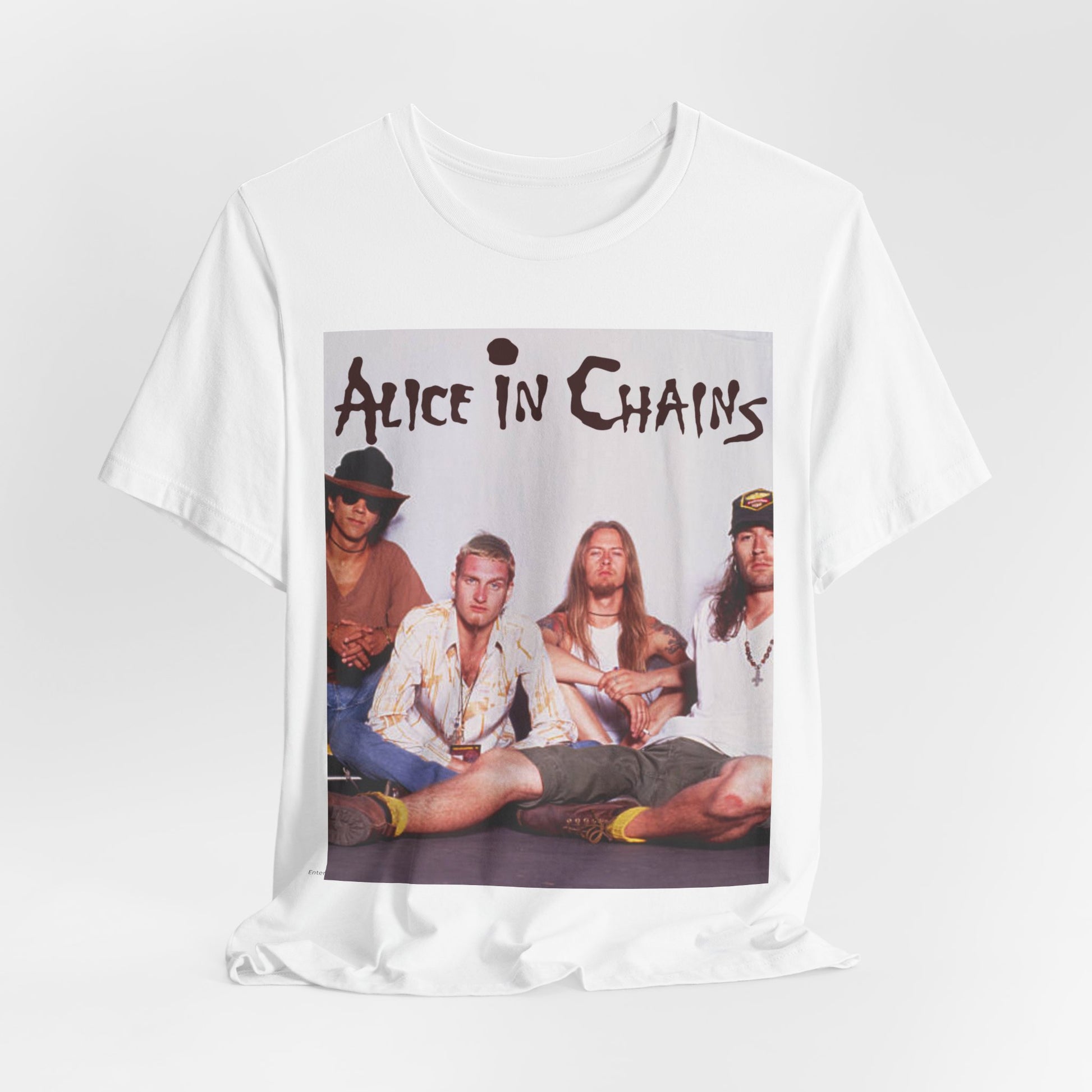 A black graphic t-shirt featuring a classic rock graphic of Alice In Chains from the 1990s, possibly with band members or stylized logo.
