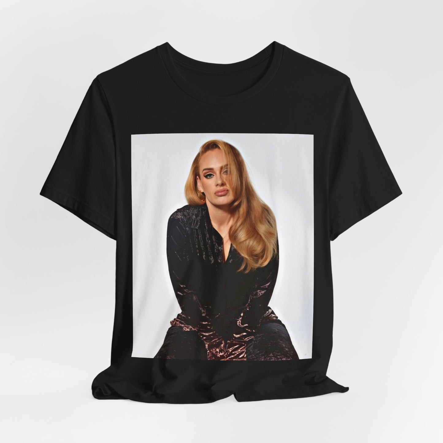 A black graphic t-shirt featuring a portrait of Adele from her iconic blonde era, with her hair styled and her expression poised and elegant.