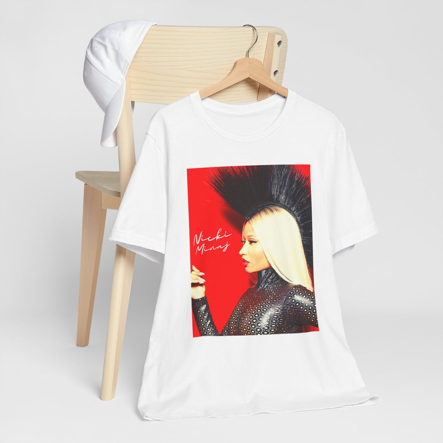 A black graphic t-shirt featuring a graphic of Nicki Minaj as a female rap pioneer.