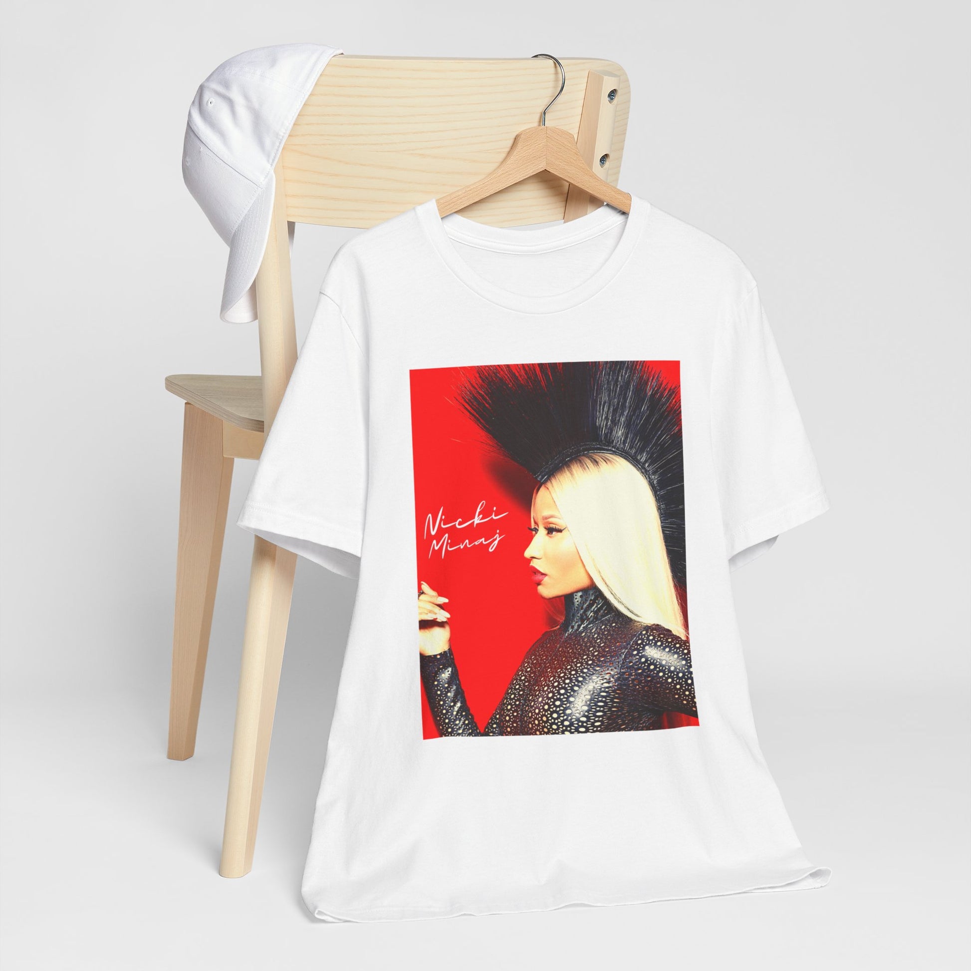 A black graphic t-shirt featuring a graphic of Nicki Minaj as a female rap pioneer.