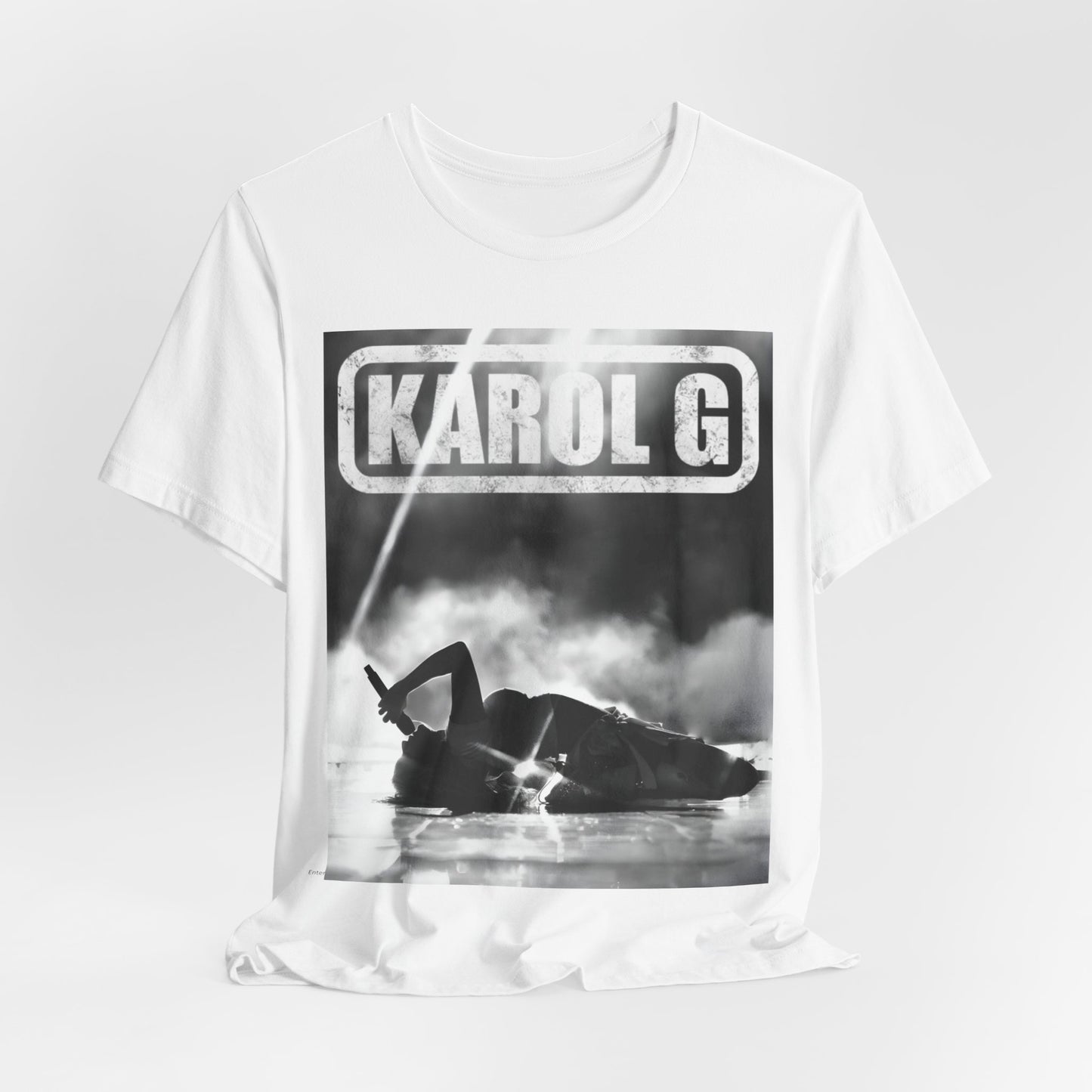 A black graphic t-shirt featuring a black and white graphic or photo of Karol G performing live on stage.