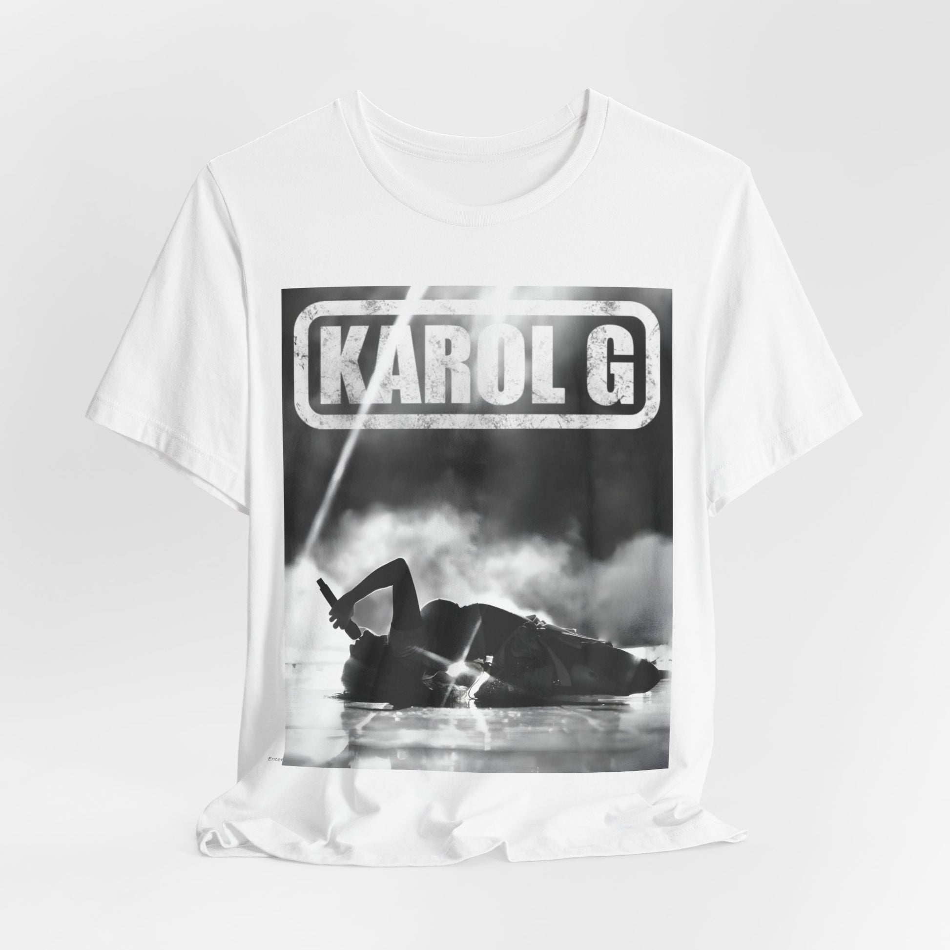 A black graphic t-shirt featuring a black and white graphic or photo of Karol G performing live on stage.