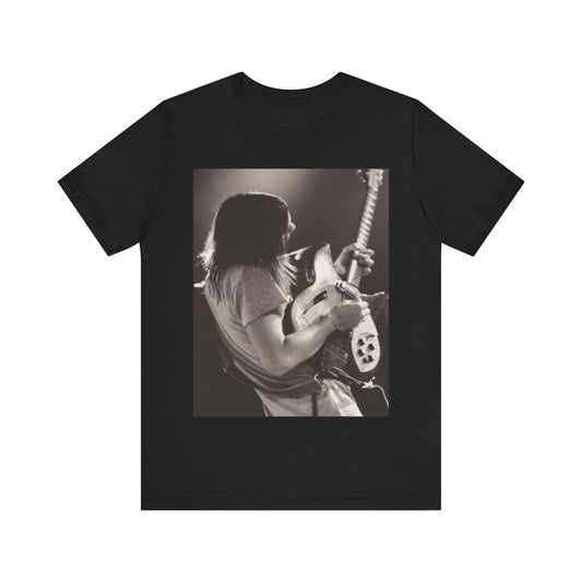 A black graphic t-shirt featuring a black and white graphic or photo of Tame Impala performing live on stage.