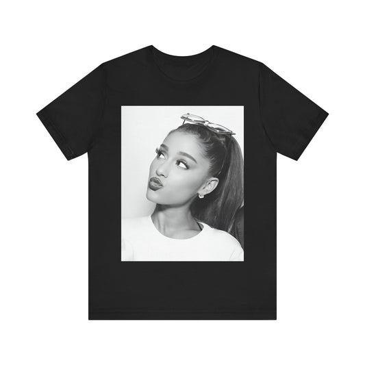 A black graphic t-shirt featuring a black and white photo of Ariana Grande in a playful or candid pose.