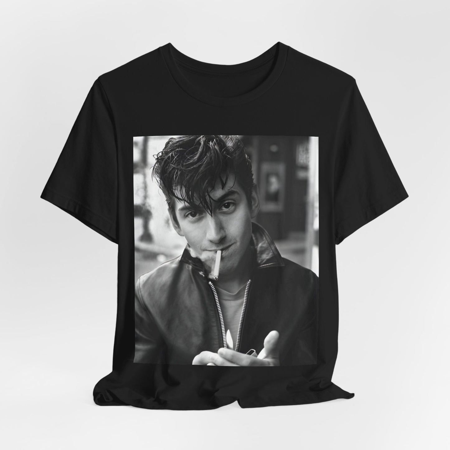A black graphic t-shirt featuring a graphic of Alex Turner from Arctic Monkeys, in a rock star pose or setting.