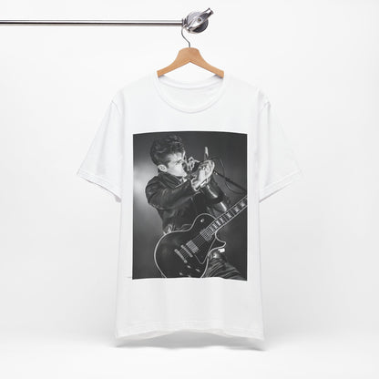 A black graphic t-shirt featuring a dynamic black and white graphic or photo of Arctic Monkeys performing live, emphasizing energy.