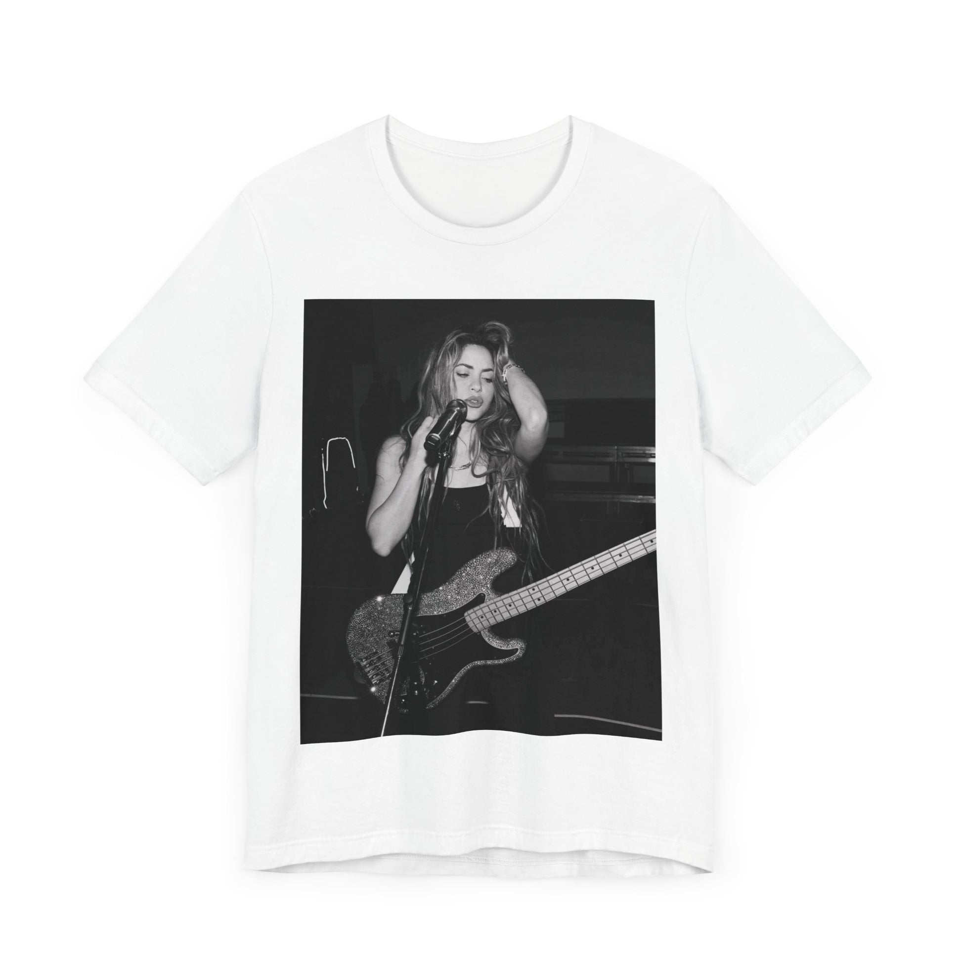 A black graphic t-shirt featuring a black and white graphic or photo of Shakira playing guitar live.