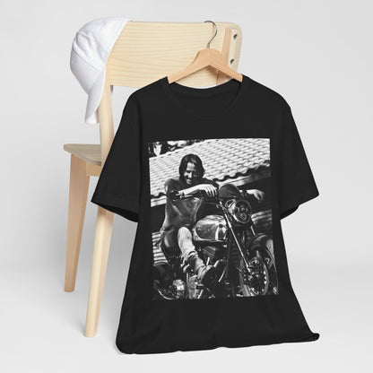 A black graphic t-shirt featuring a black and white photo of Keanu Reeves on a motorcycle.