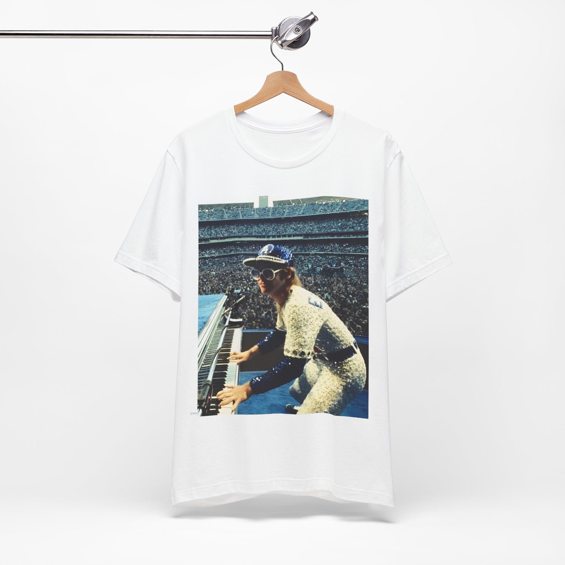 A black graphic t-shirt featuring a photo of Elton John from his 1975 Dodgers Stadium concert.