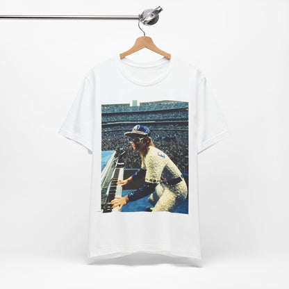 A black graphic t-shirt featuring a photo of Elton John from his 1975 Dodgers Stadium concert.