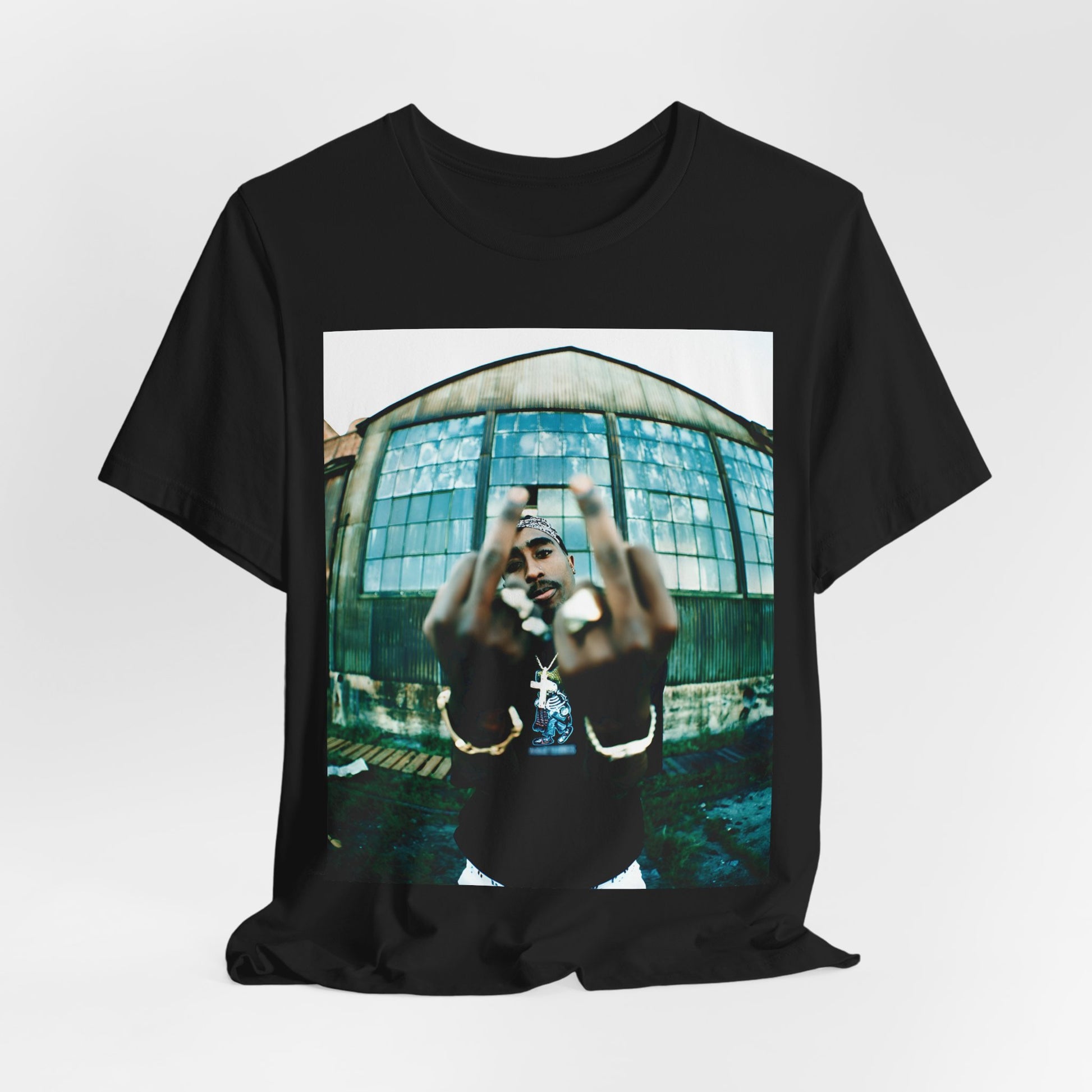 A black graphic t-shirt featuring a graphic of Tupac giving the middle finger.