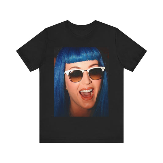 A black graphic t-shirt featuring a retro graphic of Katy Perry with blue hair.