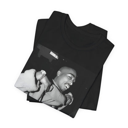 A black graphic t-shirt featuring a vintage hip hop icon graphic of Tupac.