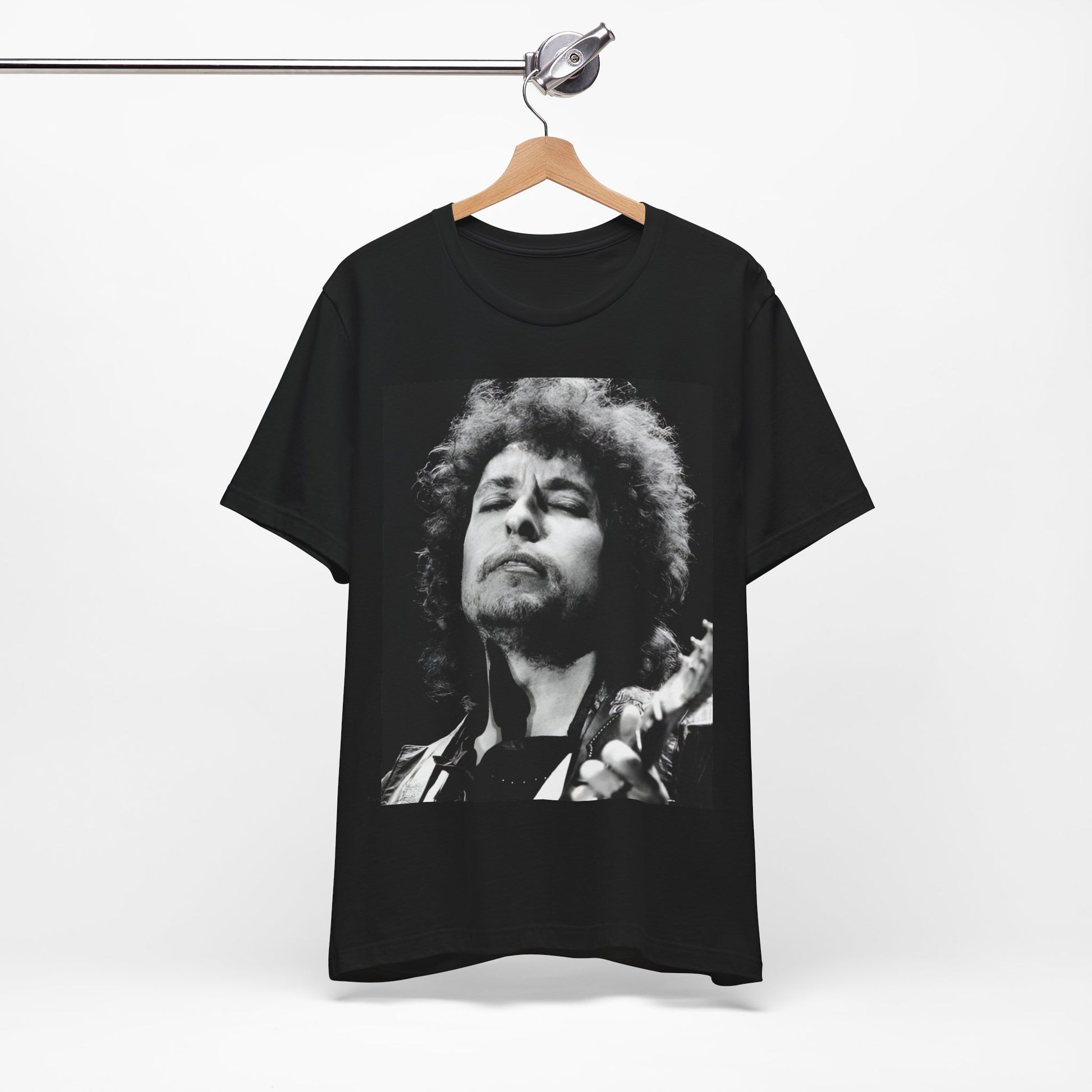 A black graphic t-shirt featuring a retro black and white graphic or photo of Bob Dylan performing live.