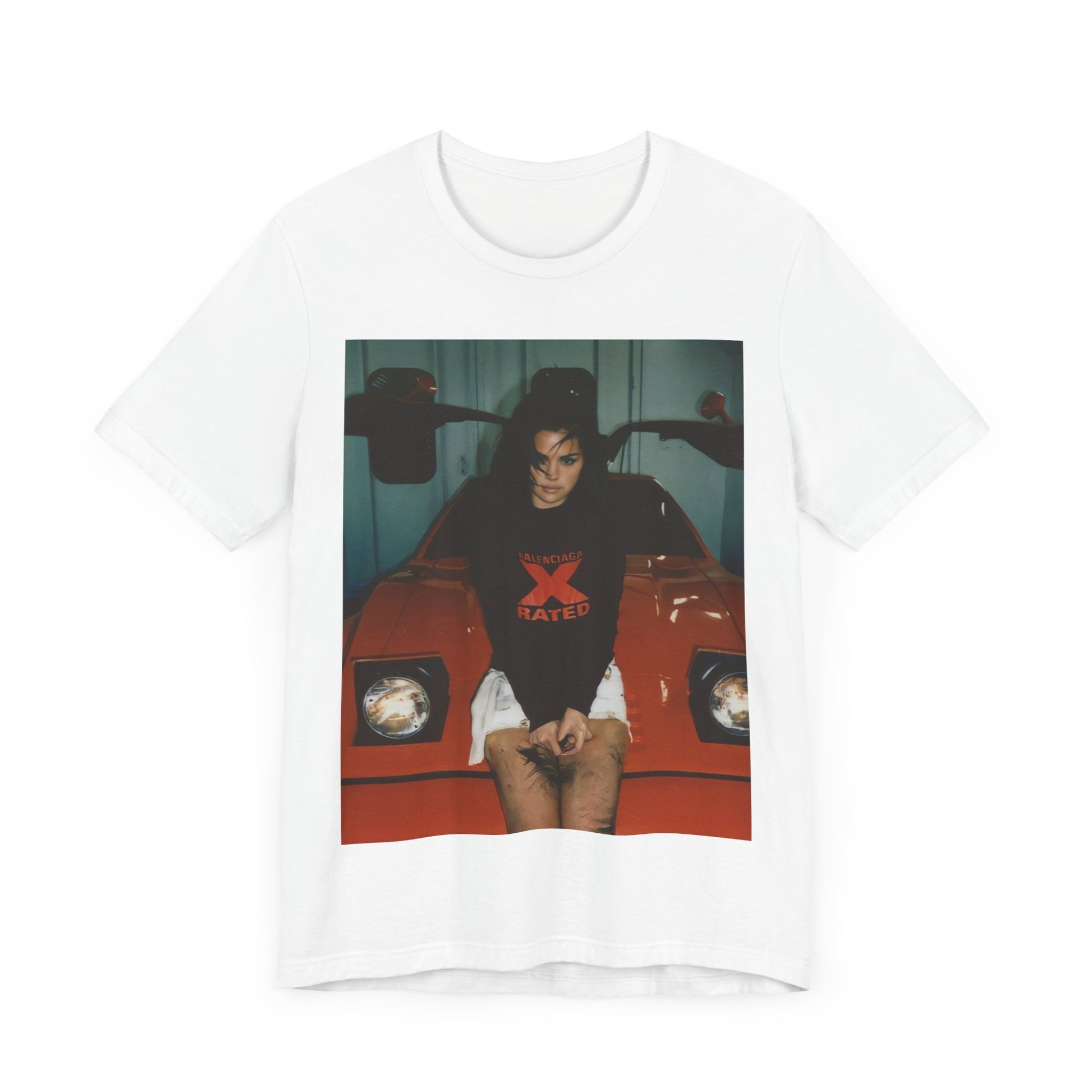 A black graphic t-shirt featuring a photo or graphic of Selena Gomez with a car, designed with an 'X Rated' or edgy aesthetic.