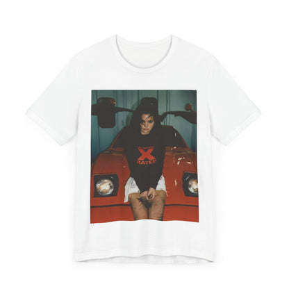 A black graphic t-shirt featuring a photo or graphic of Selena Gomez with a car, designed with an 'X Rated' or edgy aesthetic.