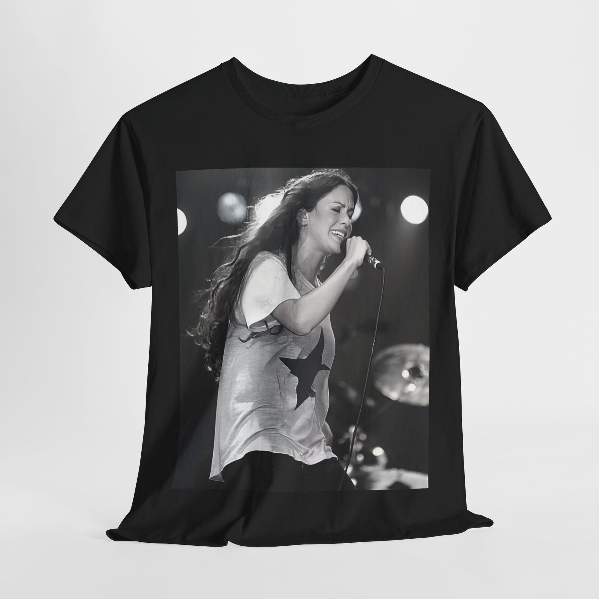 A black graphic t-shirt featuring a photo of Alanis Morissette performing live on stage in the 1990s, with a dynamic expression.