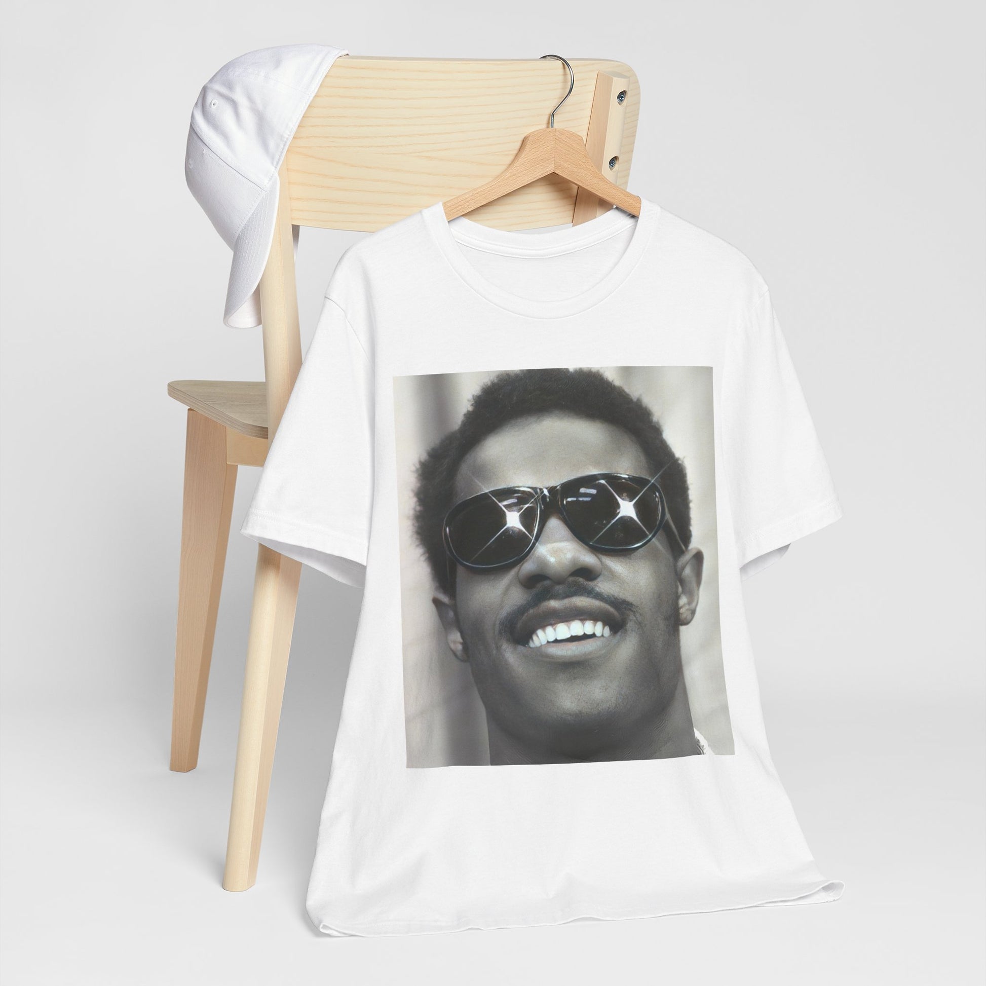 A black graphic t-shirt featuring a 70s funk aesthetic black and white graphic or photo of Stevie Wonder.