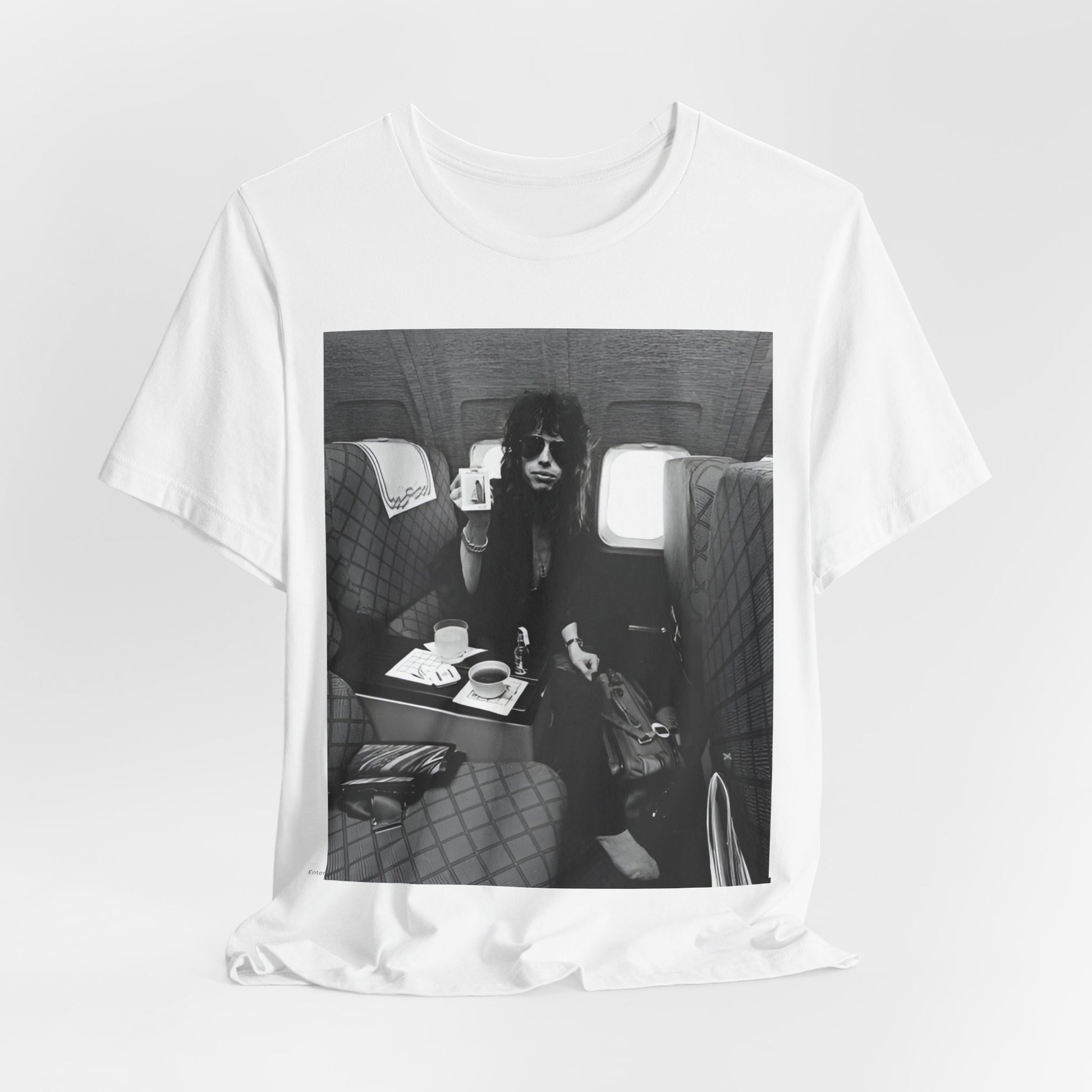 A black graphic t-shirt featuring a vintage 70s-style illustration of an airplane with Aerosmith branding, representing their tour plane from that era.