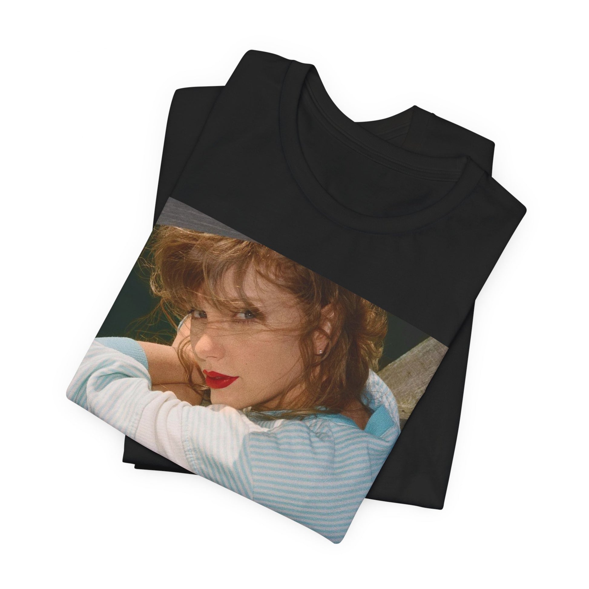 A black graphic t-shirt featuring a 1989 aesthetic graphic of Taylor Swift.
